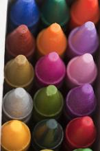 Tightly cropped top down view of tightly packed bright and dark crayon tips