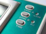 Extreme Close Up of Buttons of Handheld Electronic Video Game Console with Turquoise Face