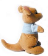 Cute little Australian plush soft toy kangaroo wearing a blue jacket viewed sideways sitting on its tail over a white background