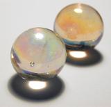 two glass marbles on a grey backdrop