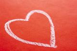 White chalk hand drawn Valentines heart on a textured red background with copyspace for a message to your sweetheart