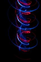 a light painted spiral of red and blue light trails