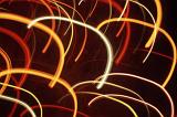 overlapping warm coloured arching light trails