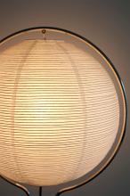 a round paper lightshade with warm white light