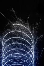 looping pattern of sparks and light trails plotting a trochoid