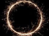 a complete circle of warm white sparks on a black background