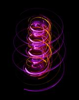 a light painted helical or spiral pattern in pink and orange