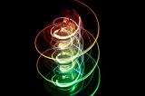 colorful red yellow and green light painted spiral pattern on a drak background