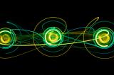 a trio of circular light painting in green and yellow with interconnected curves