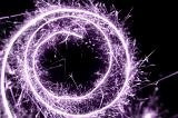 purple or lilac coloured spiral of sparkling light trails