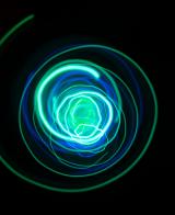 a random swirling spiral of green and blue lightpainted trails