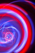 an electrifying swirl of light trails in a spiral or rotating motif