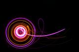 a colourful light painting with rings of pink and orange light