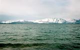 Scenic Seascape of Snow Covered Mountains on Shore of Arctic Ocean Under Cloudy Sky