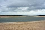 Panorama View of an Empty Tranquil Estuary Under a Dramatic Sky in the Afternoon.