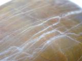 Close up of the pattern formed by quartzite veins in a smooth sandstone rock eroded by water