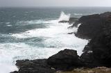 waves crashing against a rough foreboding coastline
