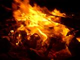Dynamic background of bright orange fiery flames burning on a dark background providing a sustainable energy and heating source