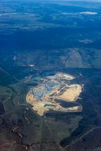 Aerial view of an opencast or strip mine scarring the landscape as the natural resources of ores or minerals are extracted from the earth