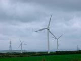 Wind turbines in open countryside. Recyclable energy concept showing use of green energy sources