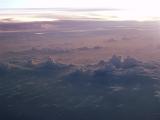 Scenic Sky Only Overview of Warm Clouds at Sunrise or Sunset as seen from Above the Clouds