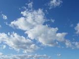 a blue sky with white fluffy clouds