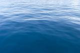 Background texture of the surface of blue sea water with ripples and reflections of sunlight for nautical or marine themed concepts