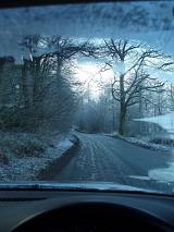 inside a car dirving along a frosty winter english lane