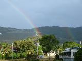 rainbows colour the sky after a passing tropical downpour, north queensland, australia