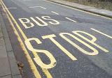 Bus stop place road marking with the sign painted on asphalt with yellow paint
