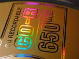 Close up on a 650mb CD-R recordable compact disk showing the rainbow colored reflection of the metallic text
