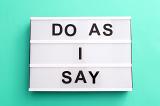 Do As I Say meme in capital letters on a small light box over a green background