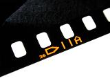 Close up on the sprockets of a vintage film strip for 35mm photography with number and forward pointing arrow isolated on white