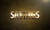 Savings sign of shining golden capital letters on dark leather background symbolising strong bank guarantees