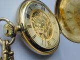 Close Up of Shiny Antique Brass or Gold Colored Pocket Watch with Roman Numerals and Open Face