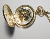 an old fashioned pocket watch with the lid popped open