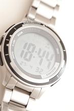 Gents sport silver metal wristwatch with a digital readout, sporting functions and circular dial, close up view on white