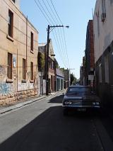 a backstreet with retro car, style and culture of urban living
