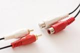 Plastic red and white RCA jack phono connectors disconnected from each other, close-up on white background