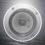 Speaker system loudspeaker under black metal lattice installed in black wooden box, close-up square image