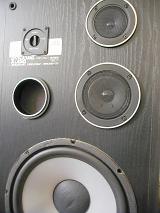 Upscale speaker system in a wooden box in a close up cropped view for an entertainment, audio or technology concept