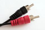 Stereo RCA phono connectors in rubber body of black and red colors, close-up on white background