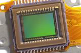 Close-up of CCD video sensor with greenish color of chip and yellow cable, full frame detail view