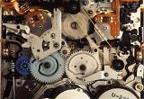 Overhead close up view of multiple different plastic and metal multicolor motors and gears as mechanical background concept