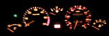 Close up of luminous car dashboard in darkness.