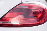 Red tail light or brake light on a white car with a close up view of the plastic lens and interior globe