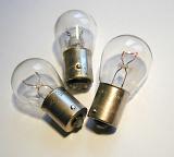 Close up on three small car lamps or globes on a white background for automotive themed concepts