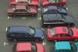 Assorted makes and colors of cars parked in a parking lot in a high angle view