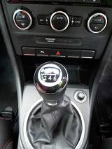 Manual gear shift in a modern car viewed from above with the console and assorted controls