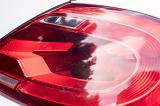 Close up detail of a red lens on a tail light of a modern white car showing the construction of the unit